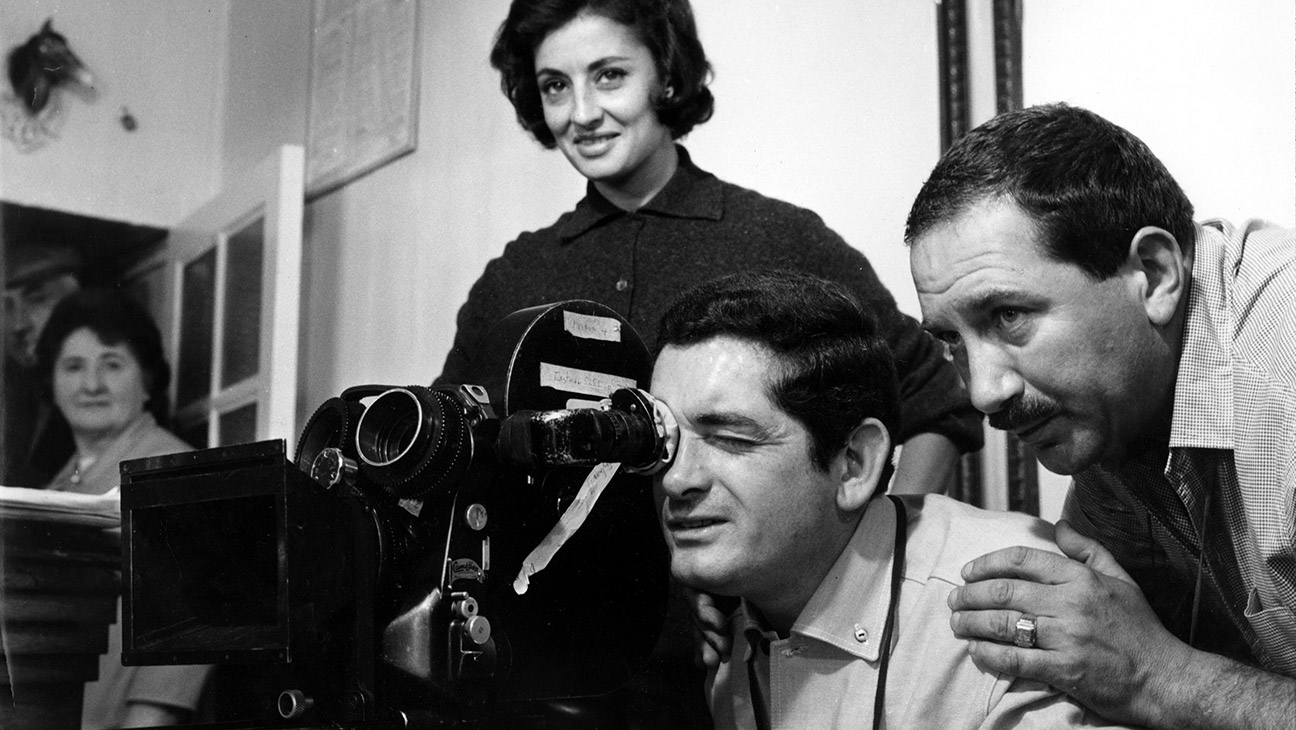 THE UMBRELLAS OF CHERBOURG, (aka LES PARAPLUIES DE CHERBOURG), Director Jacques Demy setting up a shot with cinematographer Jean Rabier (right) during filming, 1964