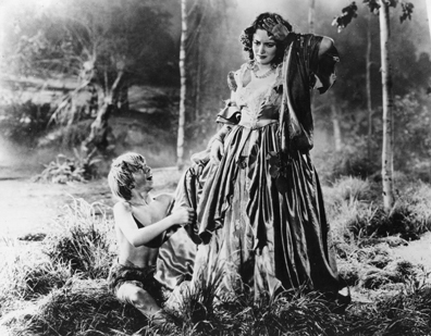 1935: Mickey Rooney as Puck and Olivia De Havilland as Hermia in a scene from Shakespeare's 'A Midsummer Night's Dream', directed by Max Reinhardt and William Dieterle for Warner. (Photo by Hulton Archive/Getty Images)