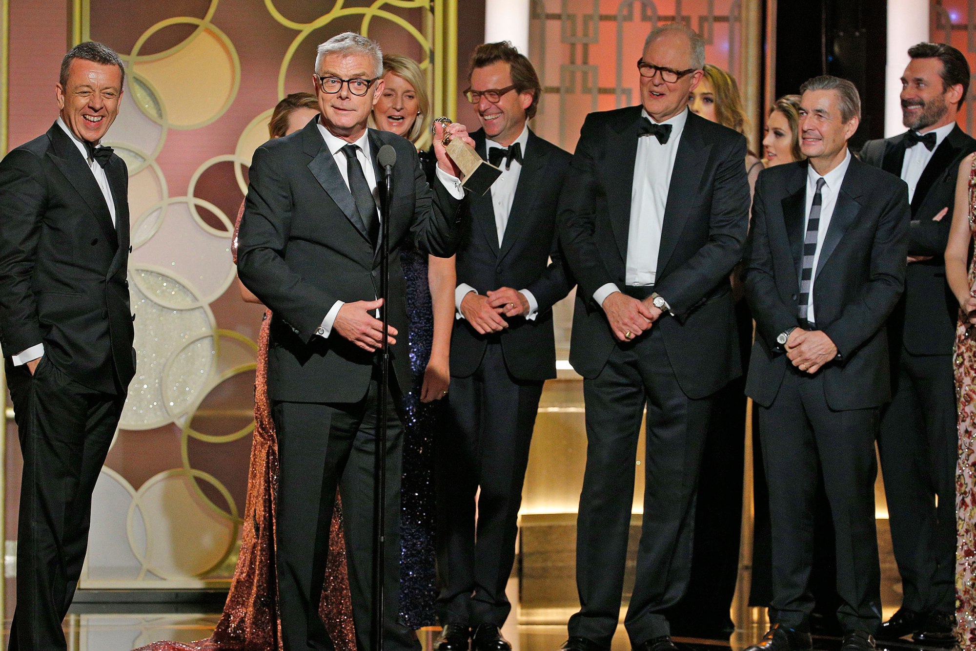 This image released by NBC shows Peter Morgan, from left, Stephen Daldry and the cast and crew of "The Crown," winner of the best drama TV series at the 74th Annual Golden Globe Awards at the Beverly Hilton Hotel in Beverly Hills, Calif., on Sunday, Jan. 8, 2017. (Paul Drinkwater/NBC via AP)